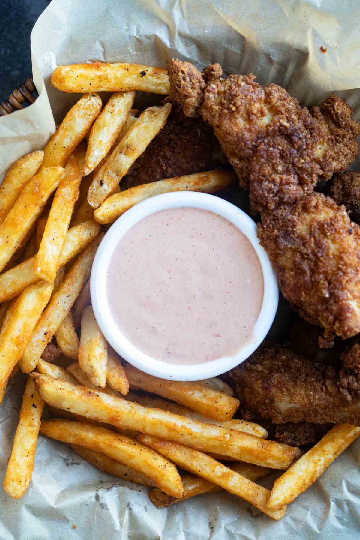 Basket filled with fries, chicken tenders, and Comeback Sauce.