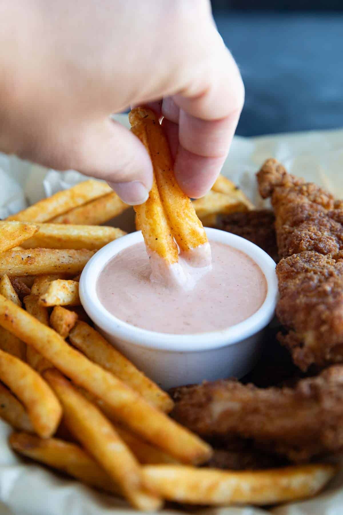 Dipping french fries in Comeback Sauce.