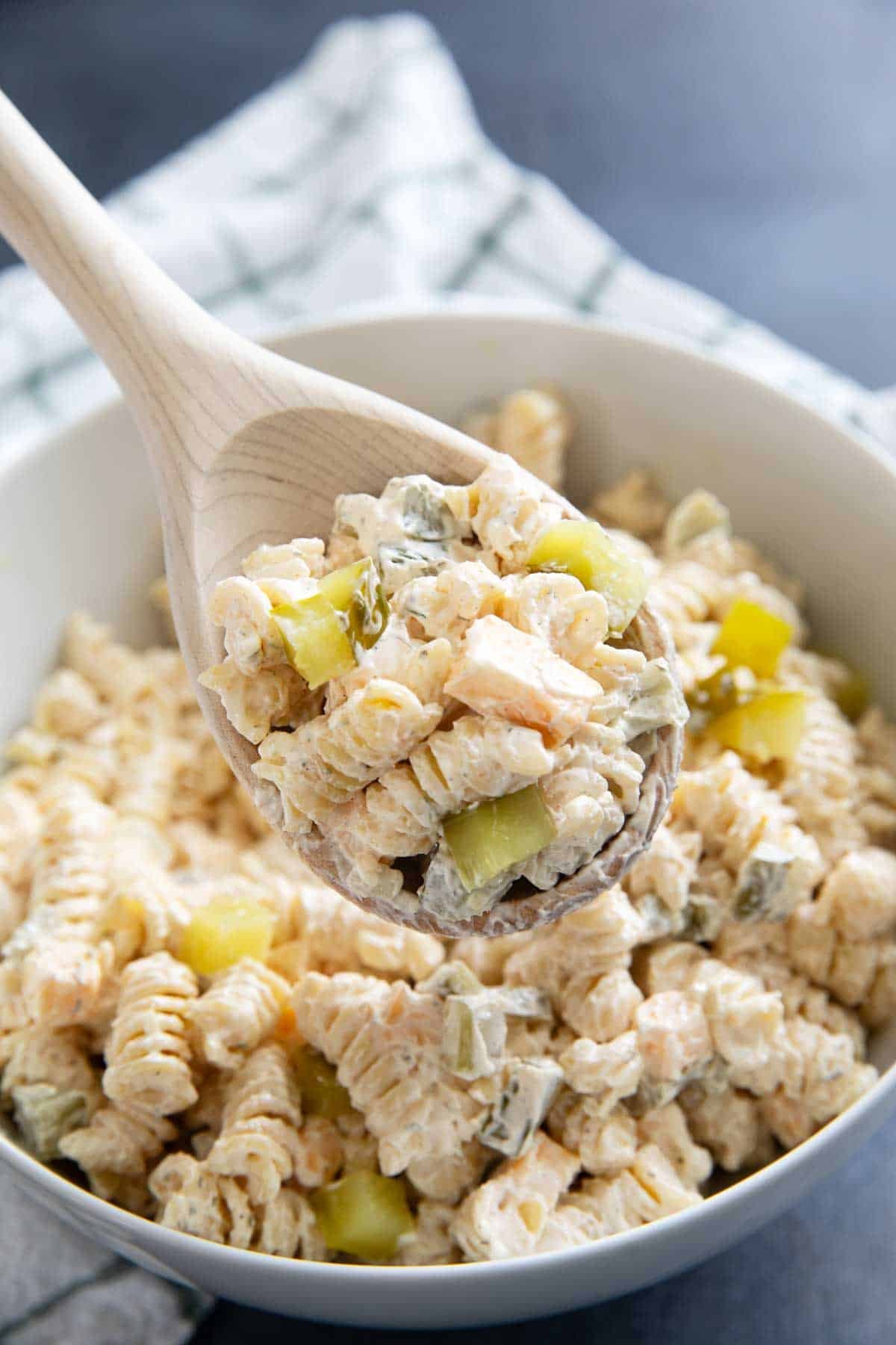 Wood spoon full of Dill Pickle Pasta Salad.