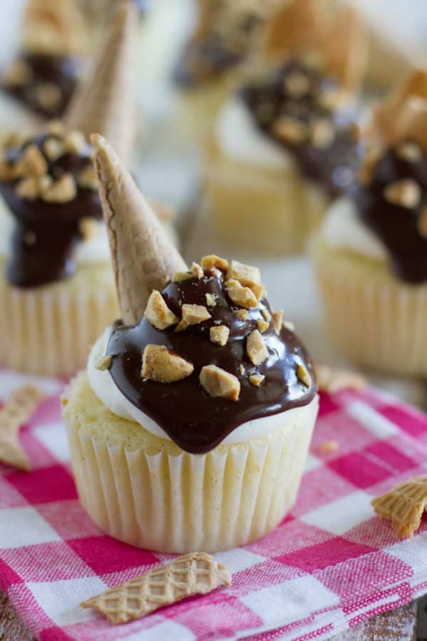 Drumstick Cupcakes topped with chocolate, peanuts, and ice cream cone pieces.