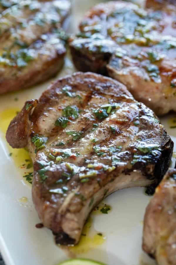 Grilled Pork Chops topped with Cilantro Lime Sauce.