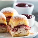 Monte Cristo Sliders on a plate with raspberry jam for serving.