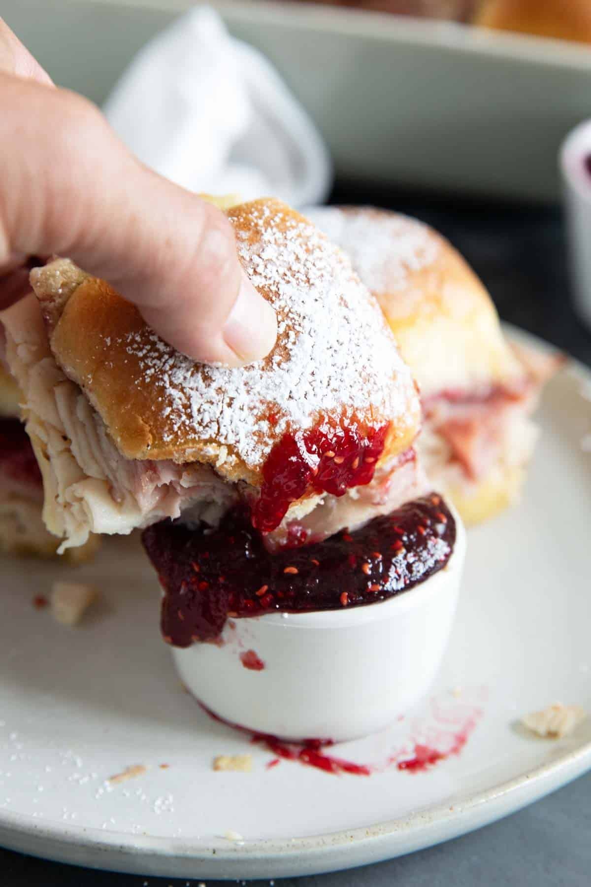 Dipping a monte cristo slider into raspberry jam.
