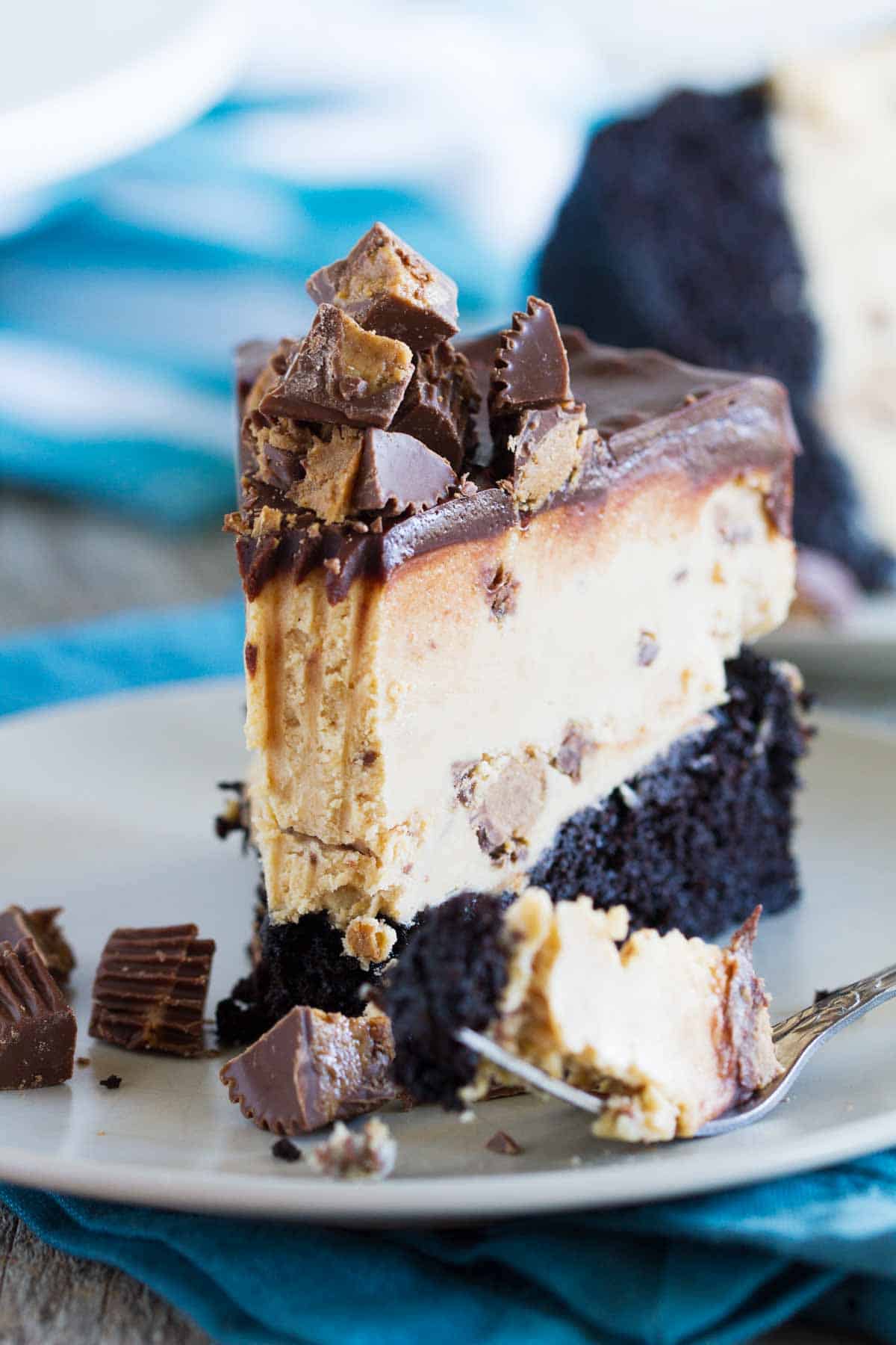 Slice of peanut butter cup ice cream cake with a bite taken from it.