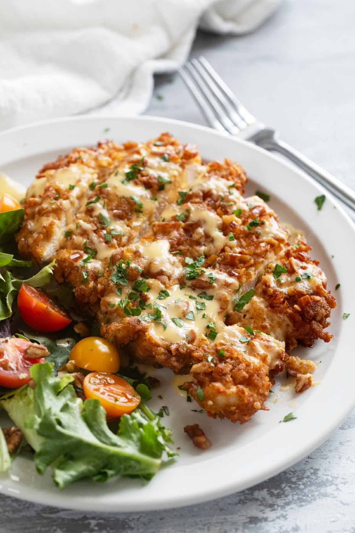 Pretzel Crusted Chicken with Mustard Cheddar Sauce on a plate.