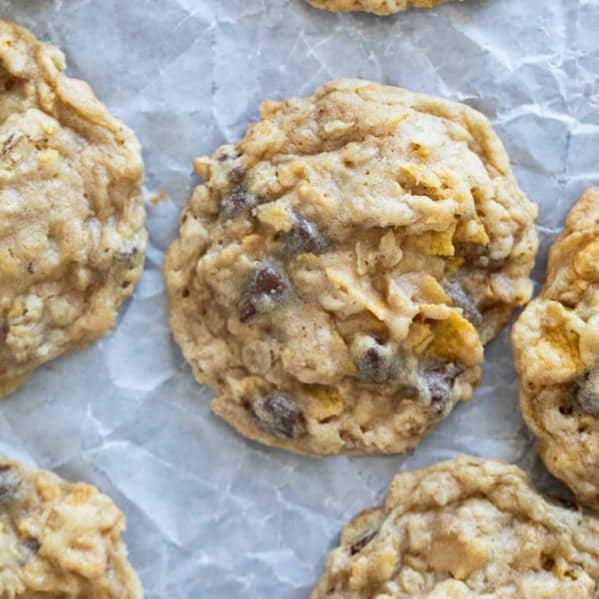 Cornflake Cookies with chocolate chips on parchment paper.