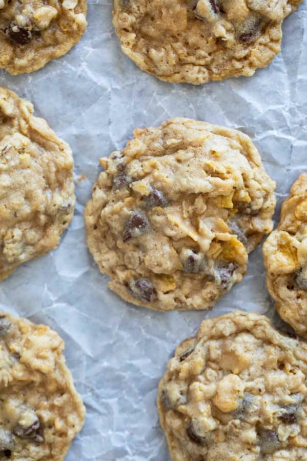 Cornflake Cookies with chocolate chips on parchment paper.