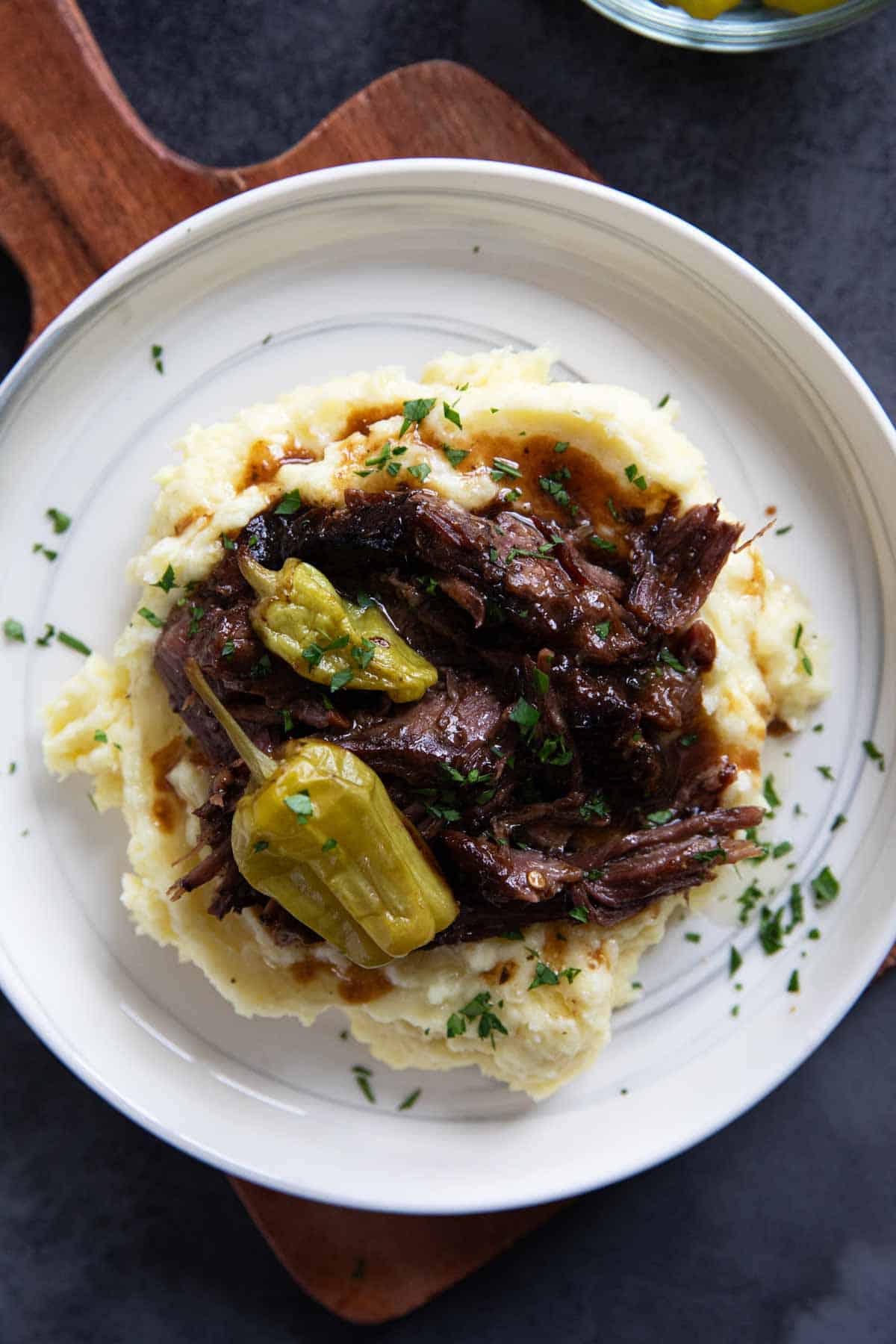 Mississippi Pot Roast with pepperoncini peppers over mashed potatoes.