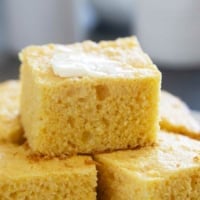 Slices of sour cream cornbread stacked on each other.