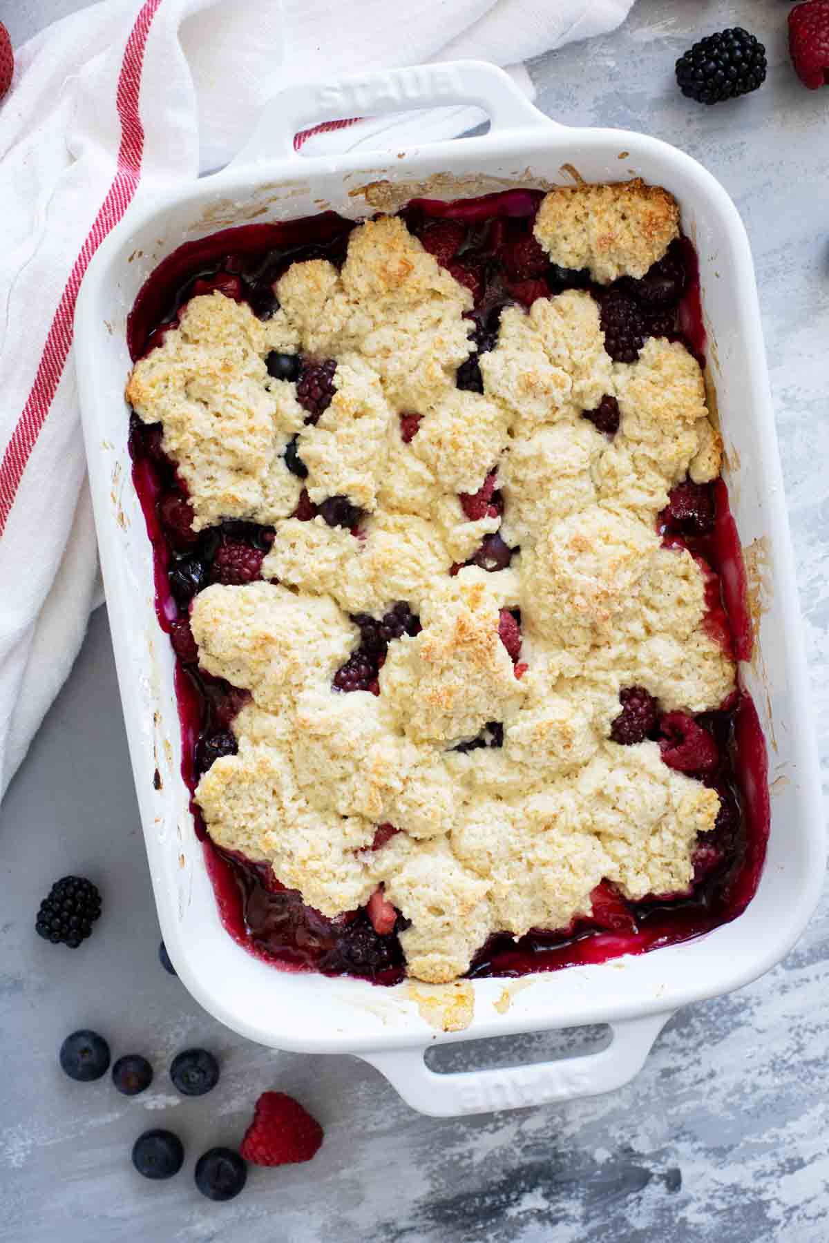 Baking dish filled with Berry Cobbler with biscuit topping.