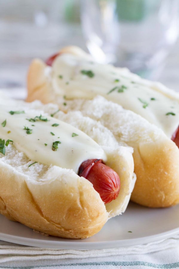 Cordon Bleu Hot Dogs with ham wrapped hot dogs and a creamy mustard cheese sauce.