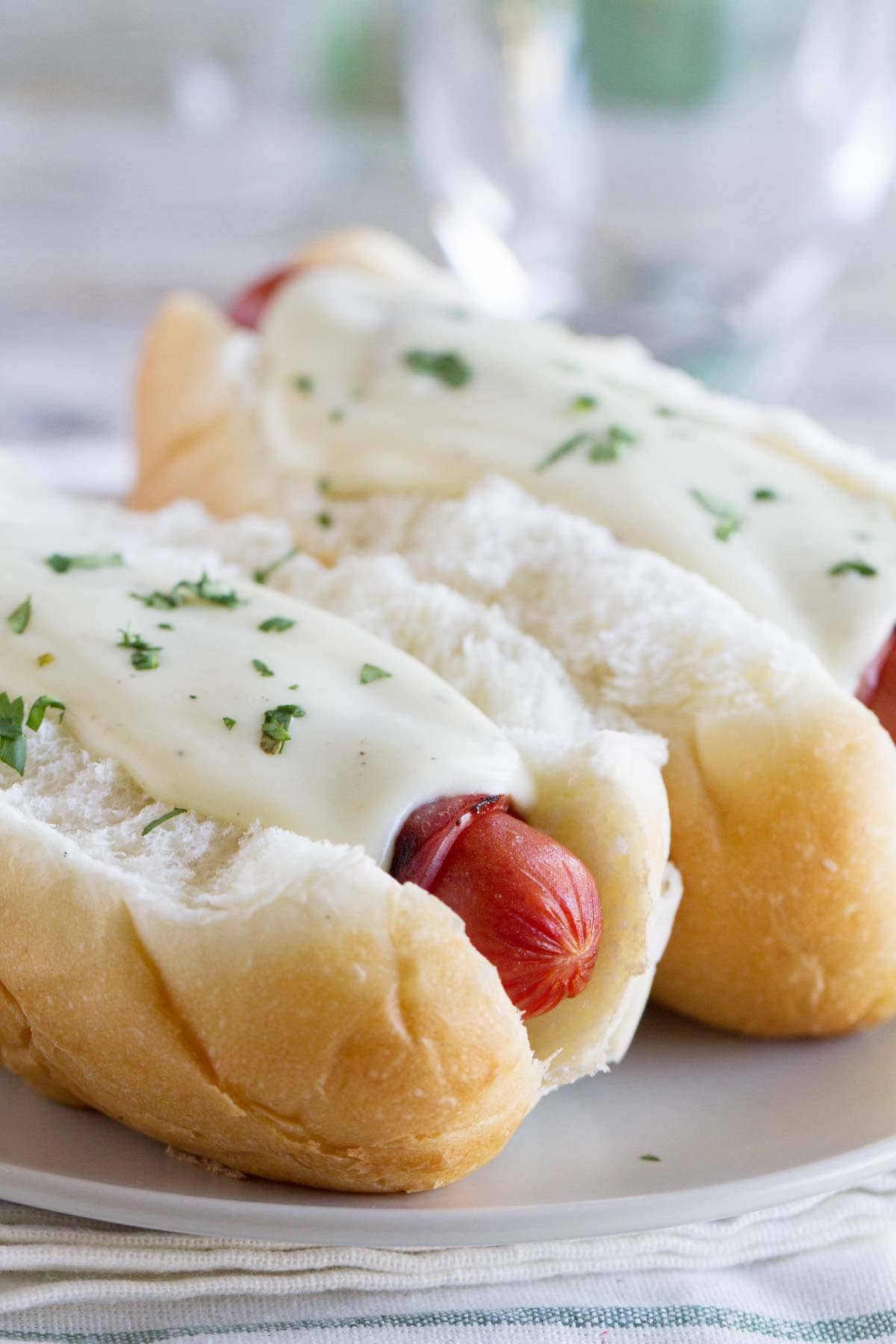 Cordon Bleu Hot Dogs with ham wrapped hot dogs and a creamy mustard cheese sauce.