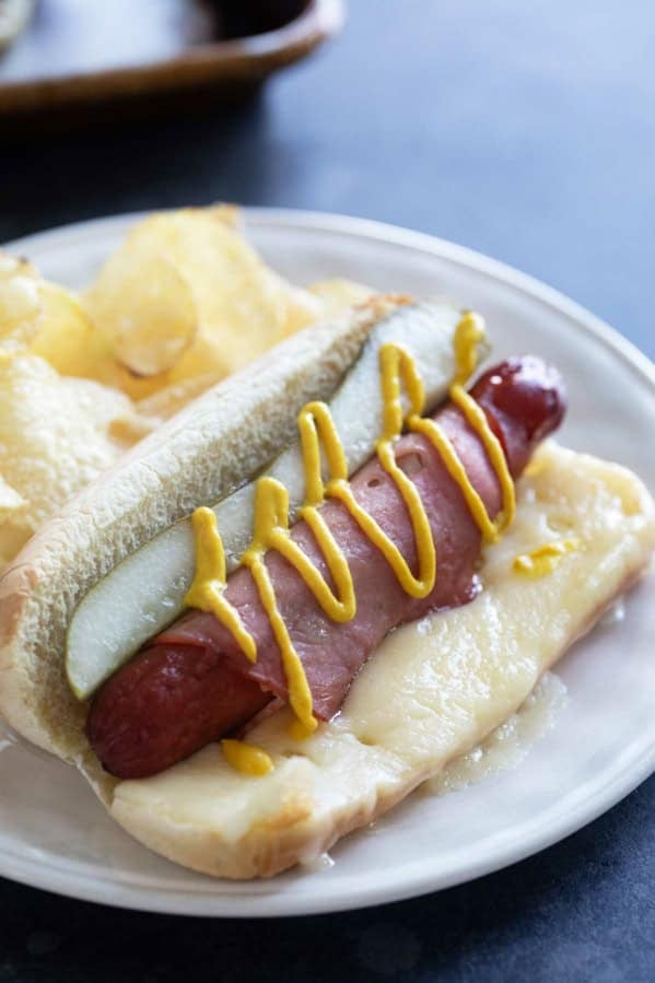 Cuban Hot Dogs with Swiss cheese, pickles, ham, and mustard.