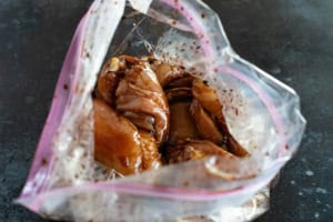 Marinating chicken thighs in a honey soy marinade.