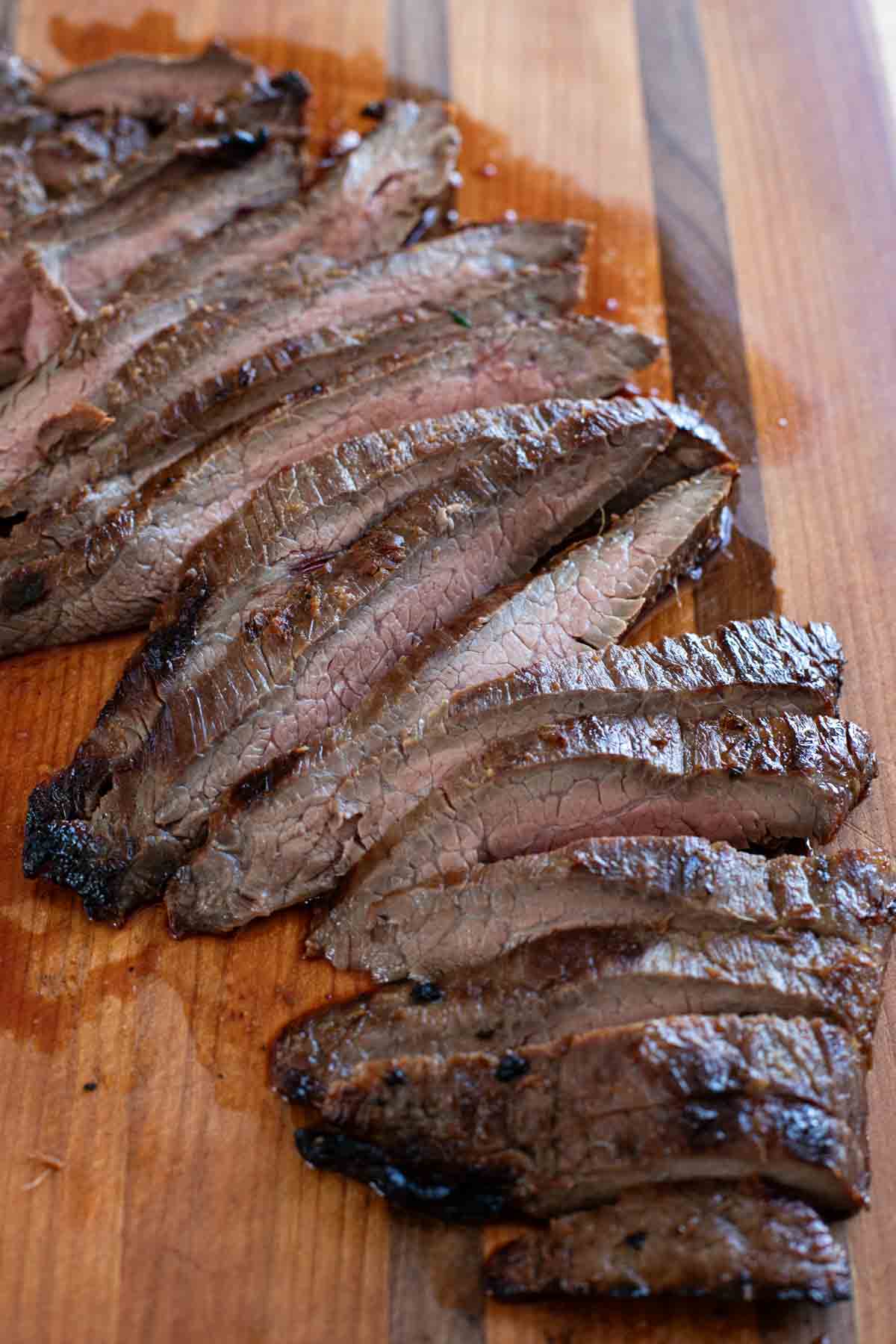 Korean flank steak on a cutting board, cut into thin slices.