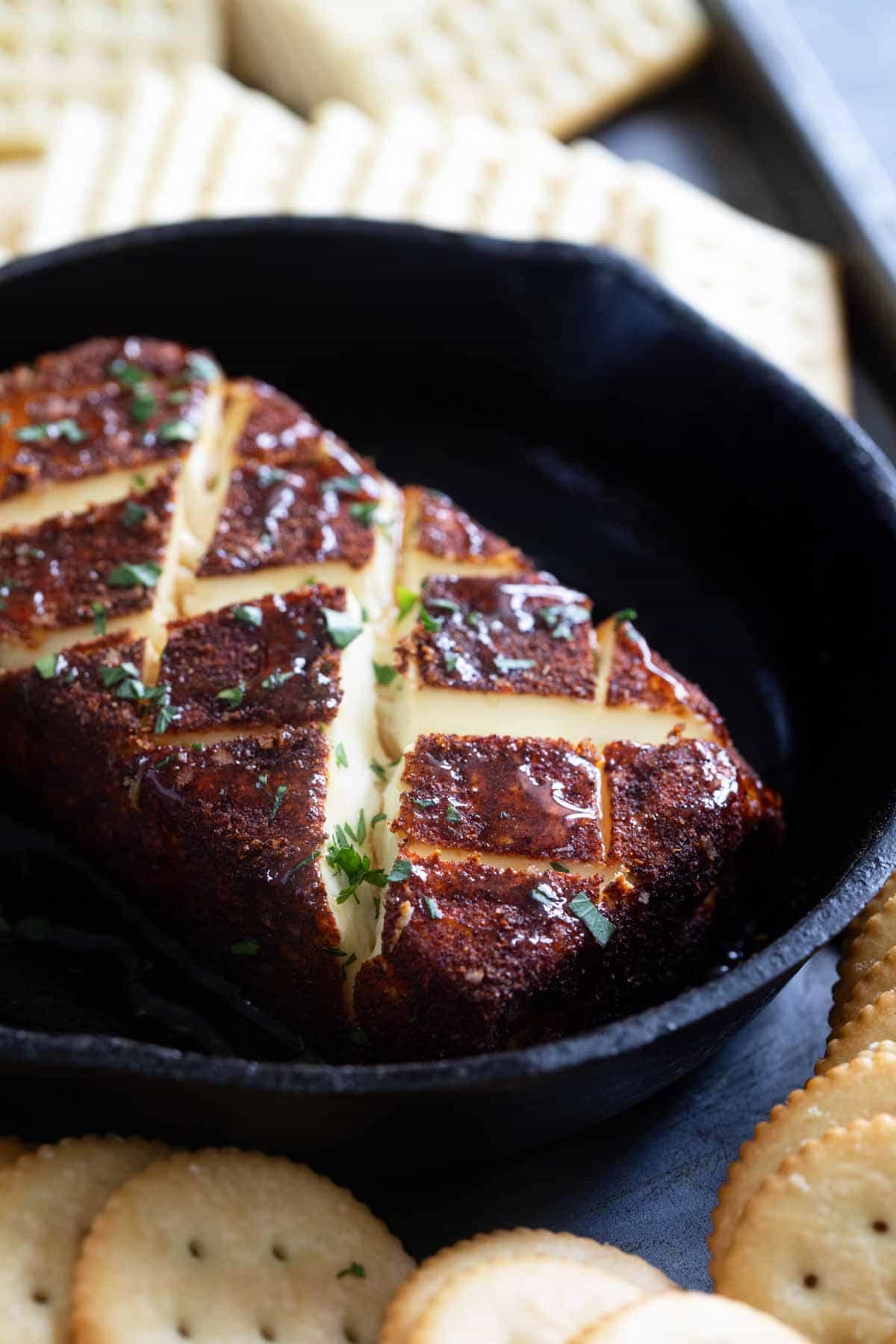 Smoked Cream Cheese topped with hot honey and parsley.