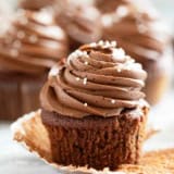 Eggless Chocolate Cupcakes with chocolate frosting with the wrapper pulled back.