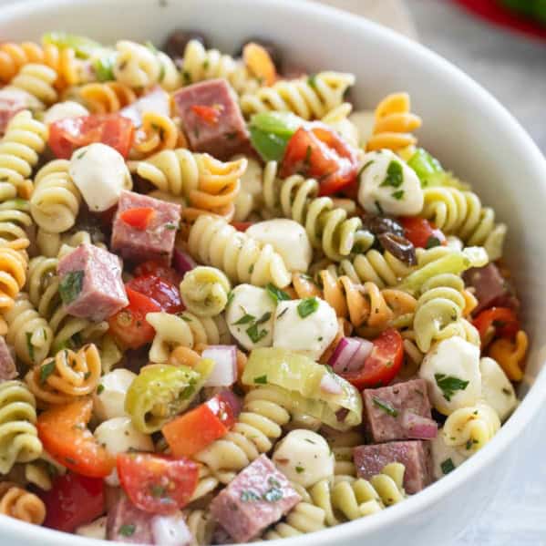 Bowl filled with Italian Pasta Salad with rotini pasta.