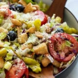 Olive Garden Salad topped with parmesan cheese.