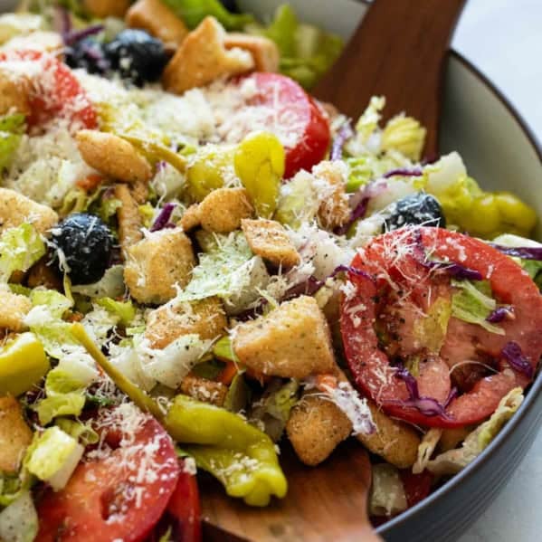 Olive Garden Salad topped with parmesan cheese.