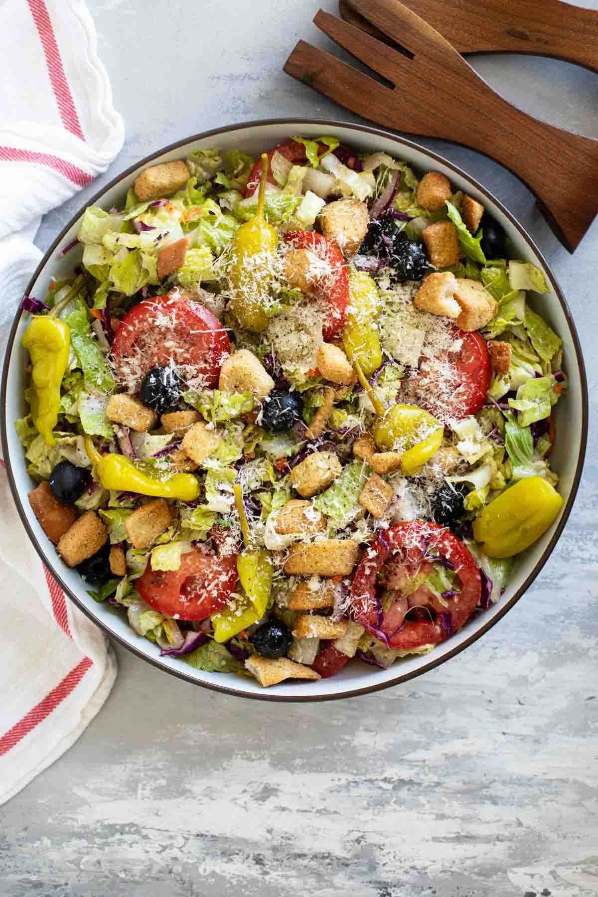 Olive Garden Salad in a large bowl with serving tongs.