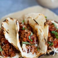 Pizza Tacos with sausage and pepperoni in flour tortillas.