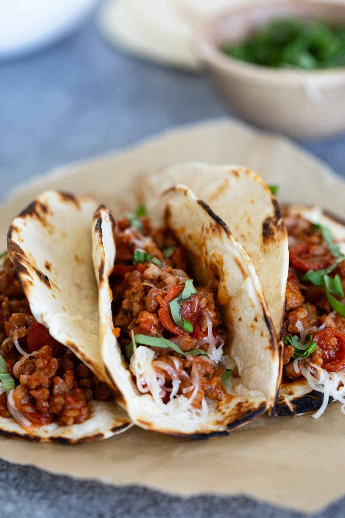 Pizza Tacos with sausage and pepperoni in flour tortillas.