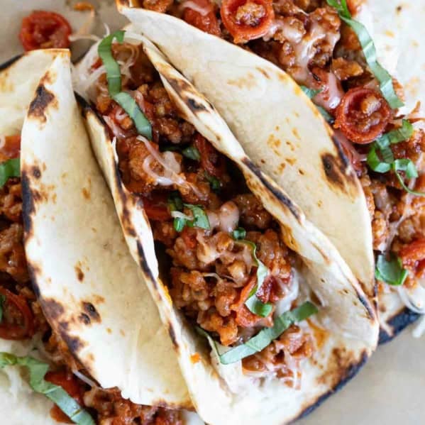 Pizza Tacos with sausage, pepperoni, cheese, and basil.