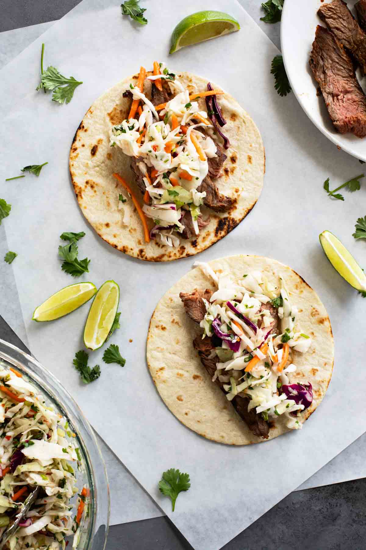 Two Thai Tacos with marinated flank steak and cilantro lime slaw.