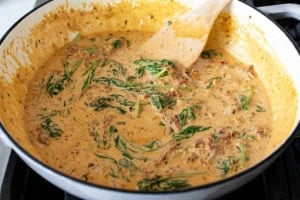 Making cream sauce for Tuscan Salmon.
