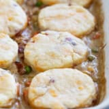 Chicken Pot Pie with Biscuits and Bacon in a white casserole dish.
