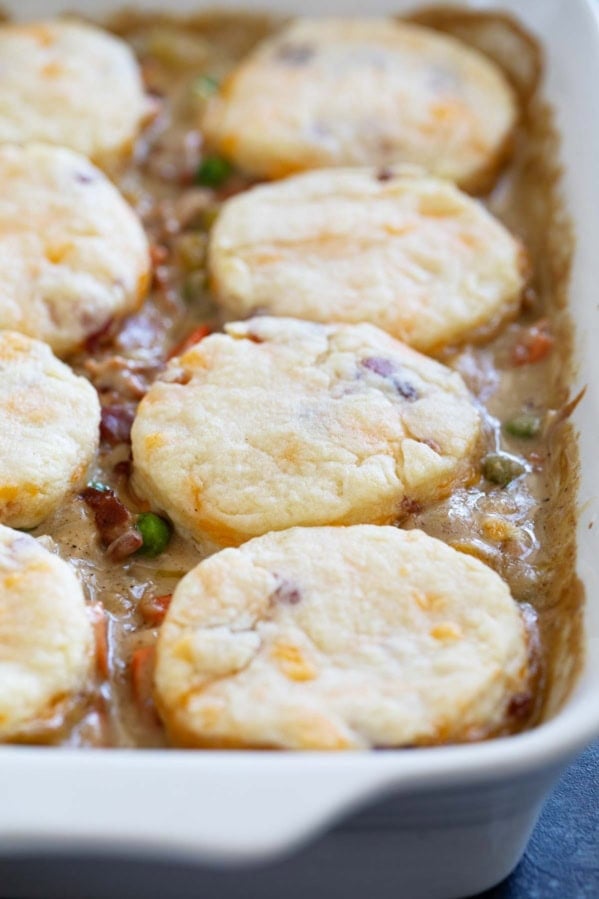 Chicken Pot Pie with Biscuits and Bacon in a white casserole dish.