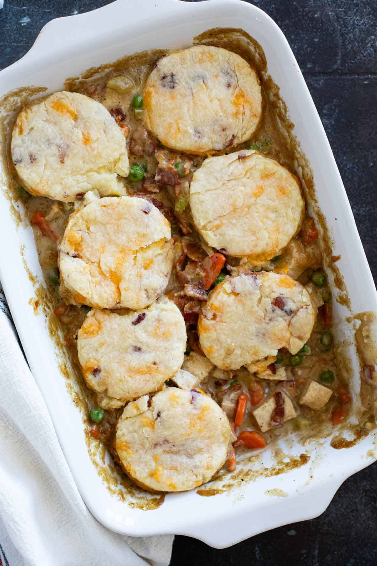 Casserole dish with Chicken Pot Pie with Bacon with a serving removed.