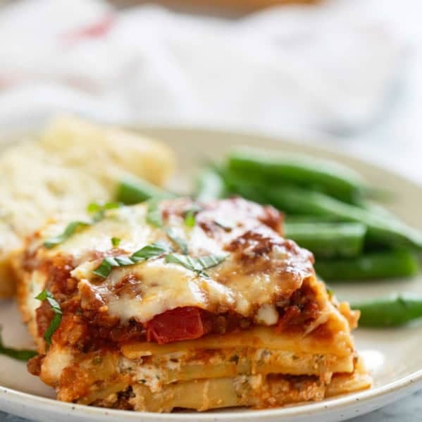 Slice of lasagna with beef and pork.