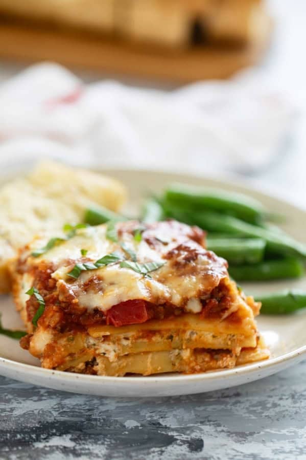 Slice of lasagna with beef and pork.