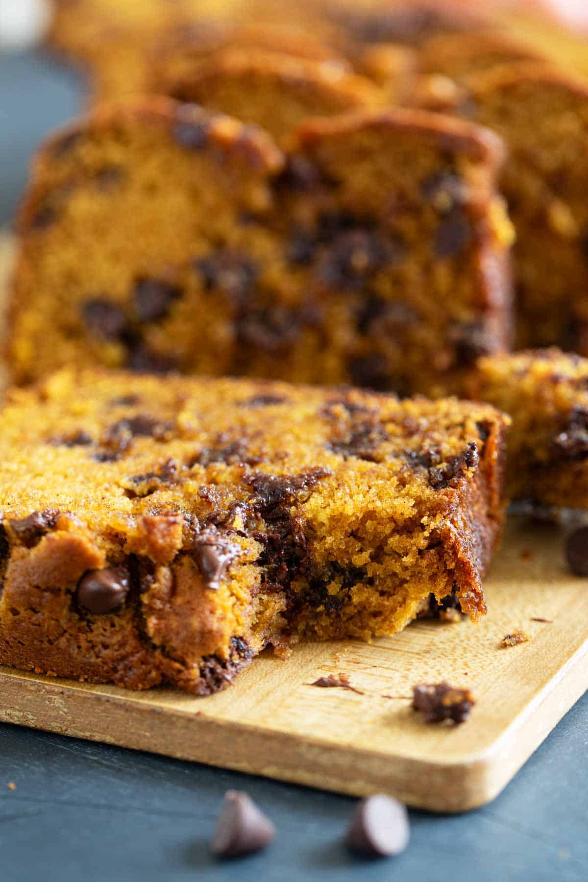 Slice of Pumpkin Chocolate Chip Bread with a bite taken from it.