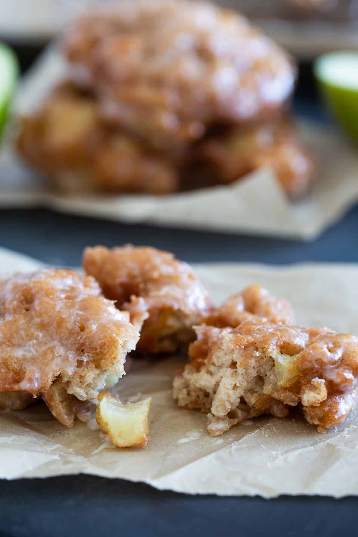 Apple fritter torn in half to show texture.