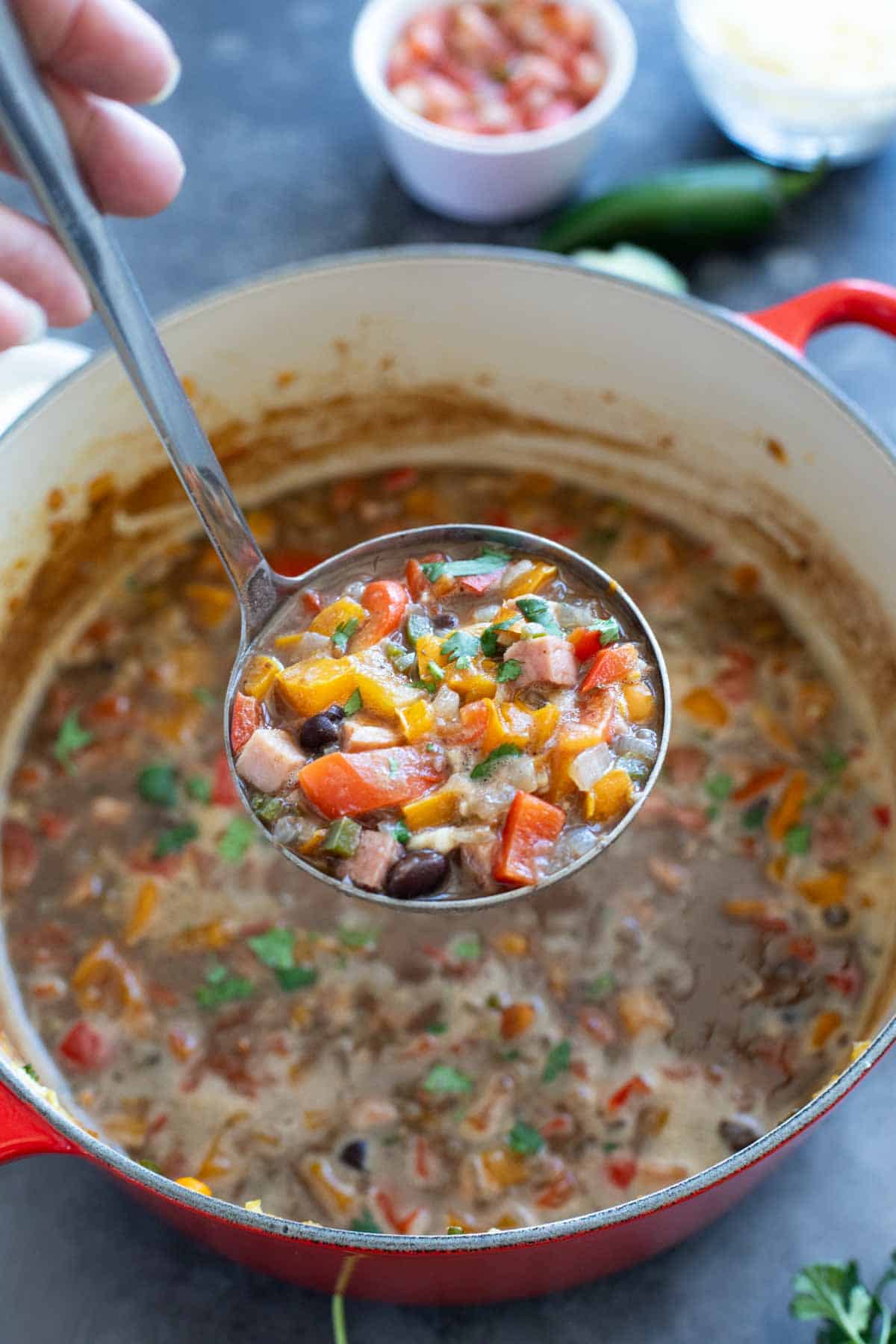 Ladle over a bowl of black bean and ham soup.