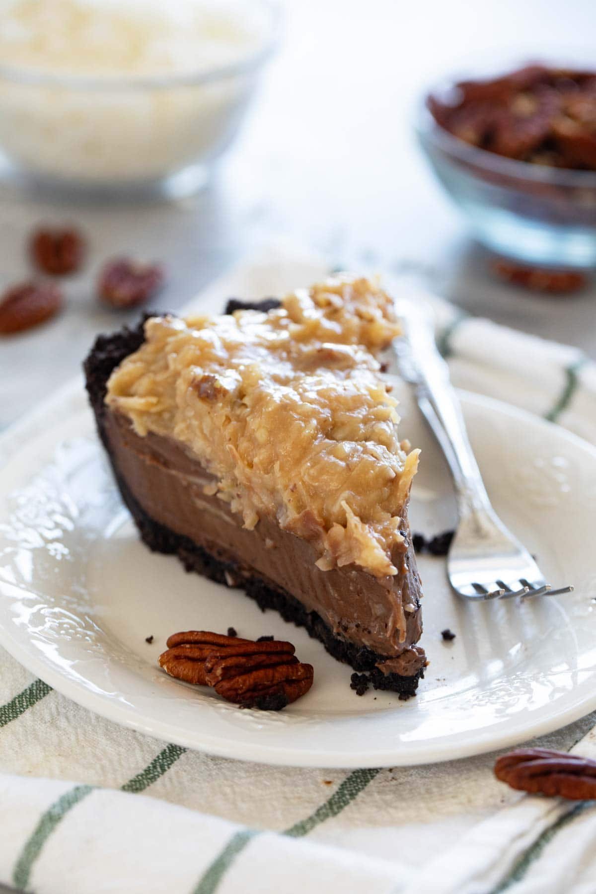 Slice of German Chocolate Pie topped with coconut pecan topping.