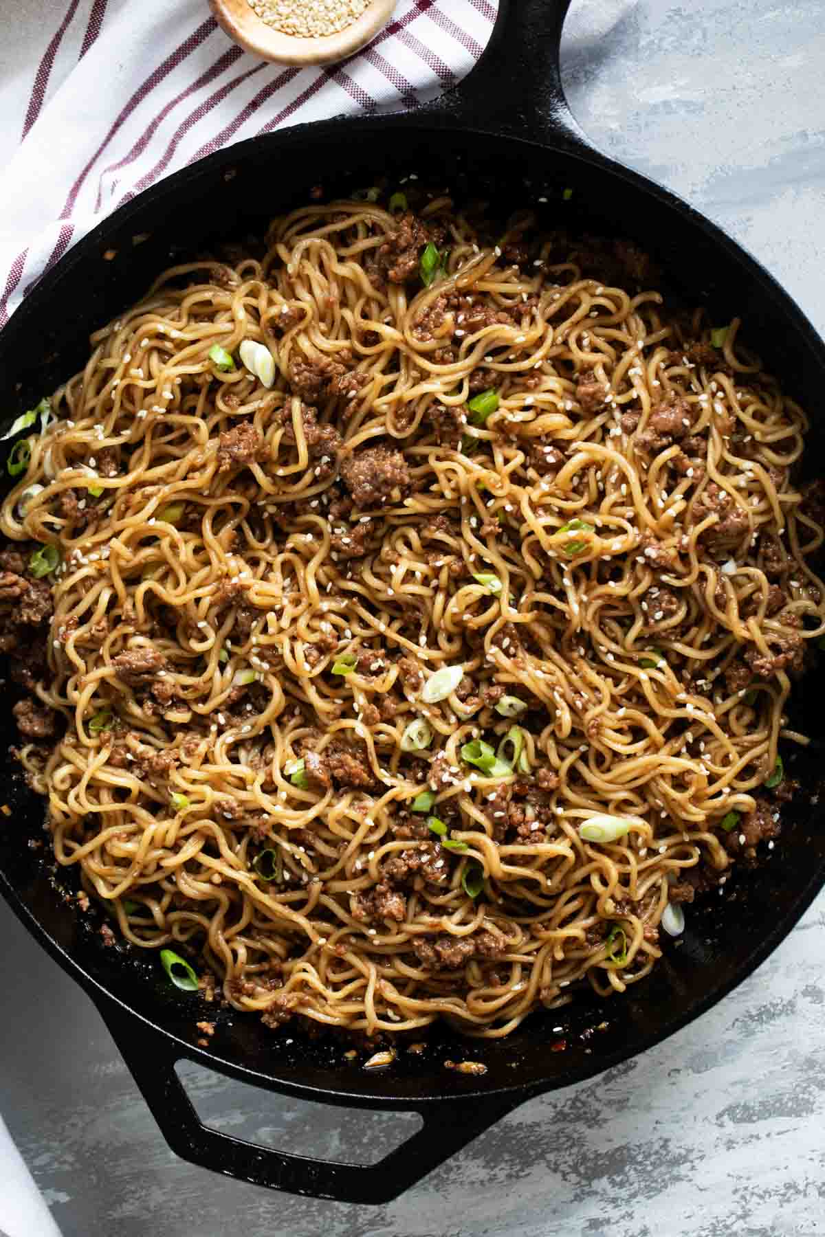 Cast iron skillet filled with Mongolian ground beef noodles.