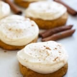 Soft Pumpkin Cookies with Cream Cheese Frosting with cinnamon dusted on top of cookies.