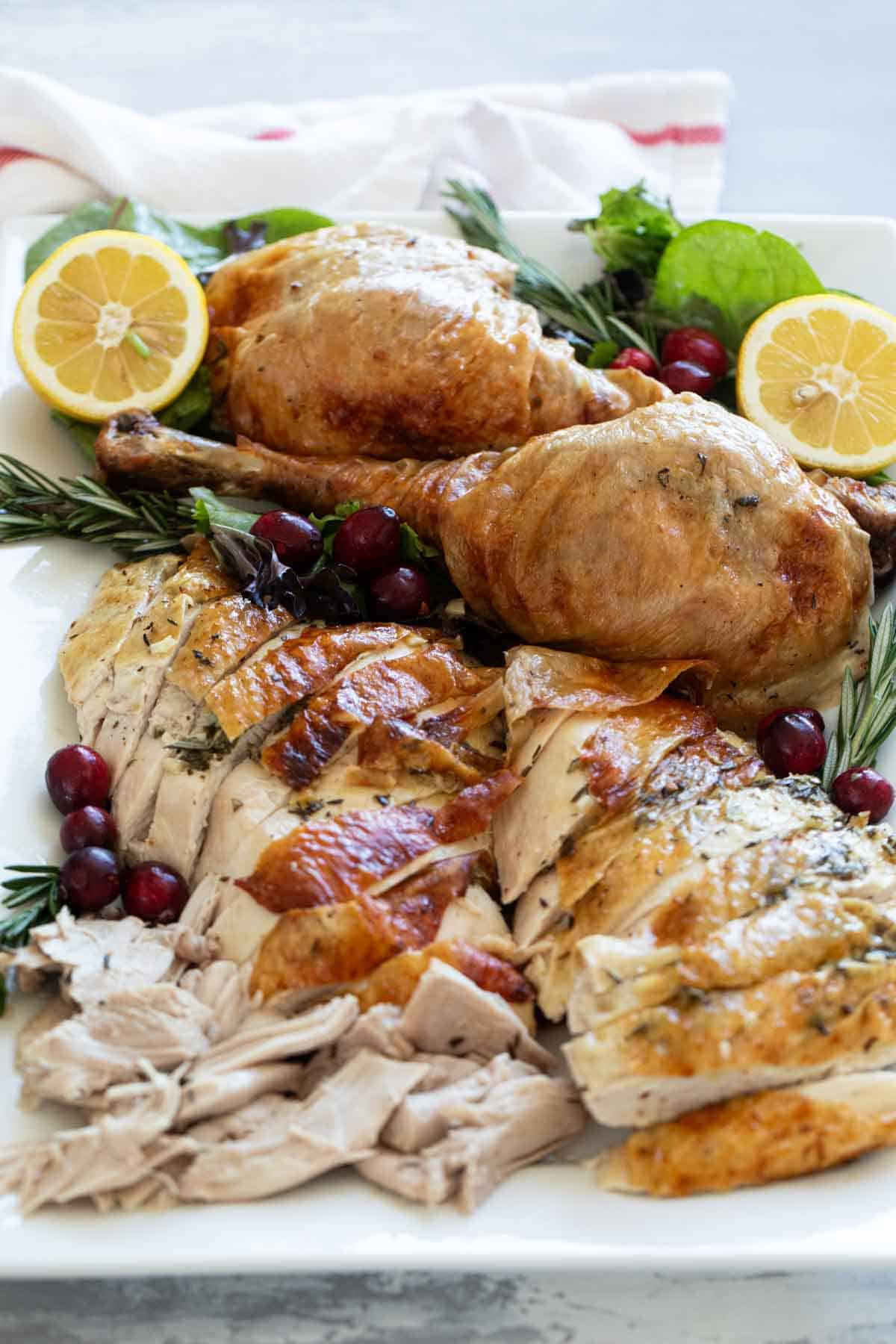 Sliced roast turkey on a serving dish.