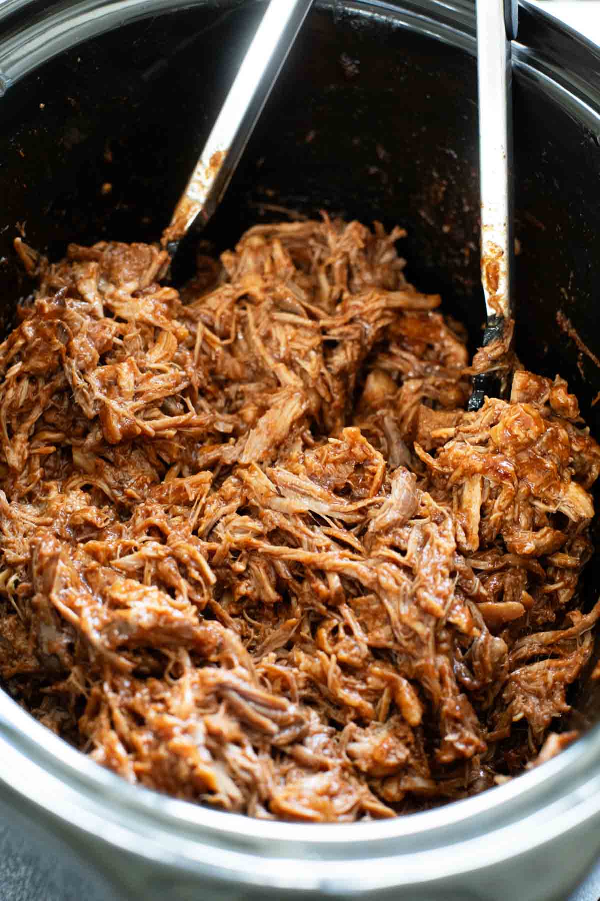 Crock pot filled with bbq pulled pork.