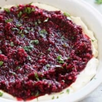 Cranberry Cream Cheese Dip in a dish, topped with chopped cilantro.