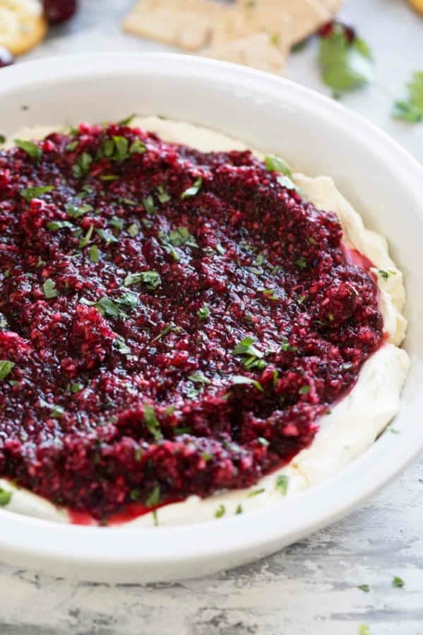 Cranberry Cream Cheese Dip in a dish, topped with chopped cilantro.