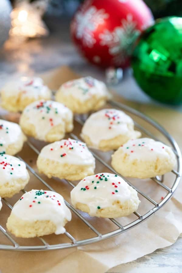 Italian Christmas Cookies topped with glaze and holiday sprinkles.