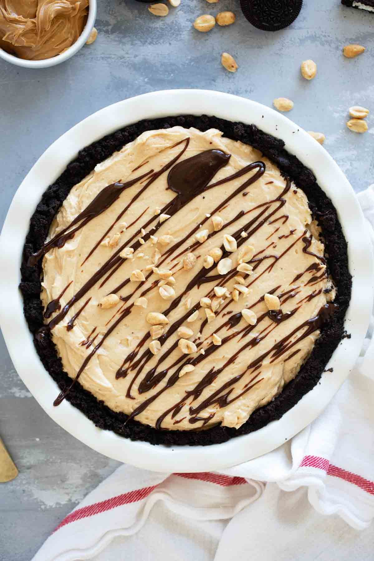 Full peanut butter pie with hot fudge drizzle on top.