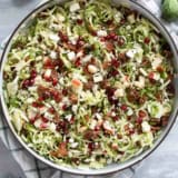 Shaved Brussels Sprout Salad with apples, pomegranates, candied pecans, feta, and bacon.