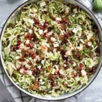 Shaved Brussels Sprout Salad with apples, pomegranates, candied pecans, feta, and bacon.