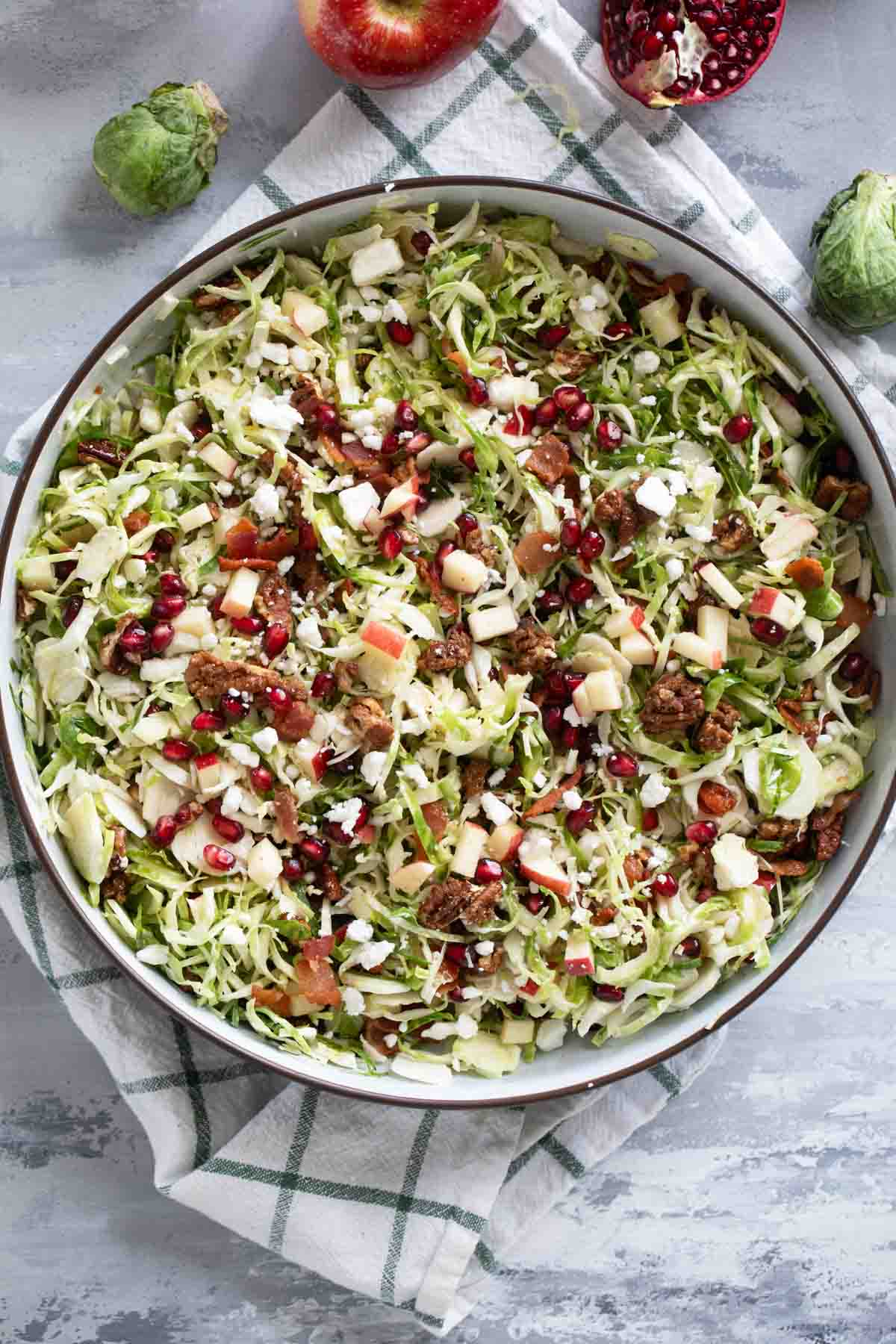Shaved Brussels Sprout Salad with apples, pomegranates, candied pecans, feta, and bacon.
